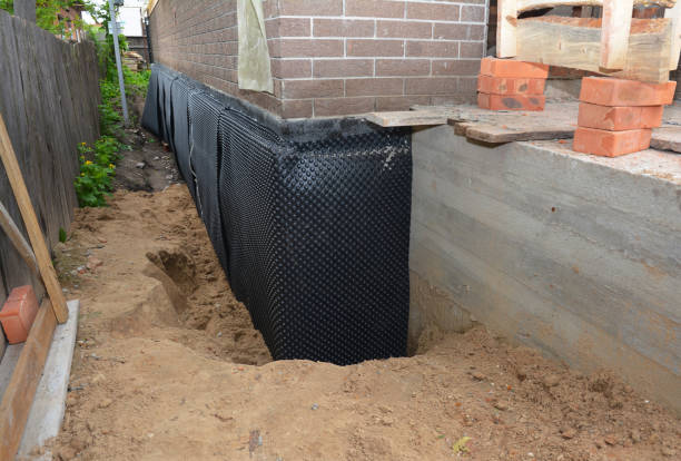 Happy homeowners after waterproofing job in Titus